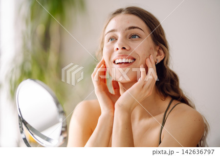Portrait of a young woman without makeup with Acne skin. Concept of acne therapy and problem skin. Portrait of a young woman without makeup with Acne skin. Concept of acne therapy and problem skin. 142636797