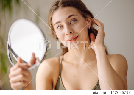Portrait of a young woman without makeup with Acne skin. Concept of acne therapy and problem skin. Portrait of a young woman without makeup with Acne skin. Concept of acne therapy and problem skin. 142636798