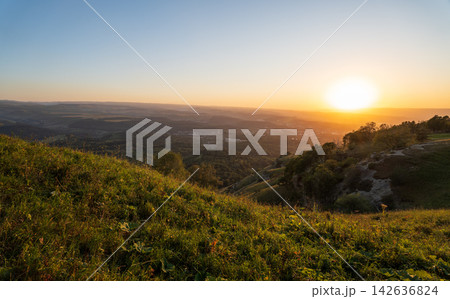 View of the mountains and Kislovodsk from the observation decks of the Kislovodsk Park. Evening sunset over the mountains of Kislovodsk. View of the mountains and Kislovodsk from the observation decks of the Kislovodsk Park. Evening sunset over the mountains of Kislovodsk. 142636824