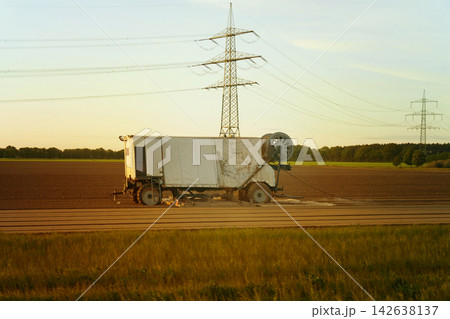 Abandoned vehicle under the golden sunset in a vast field Abandoned vehicle under the golden sunset in a vast field 142638137