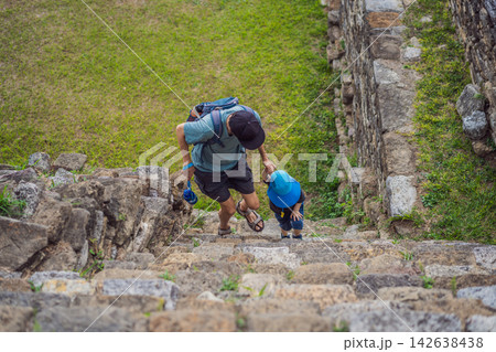 Father and little son climbing ancient stone stairs at Tonina Maya ruins in Chiapas Mexico with pre Hispanic history stone walls cultural heritage Mexican archaeology and side view. 142638438