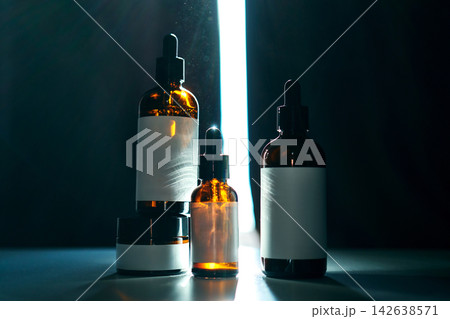 Skincare and cosmetic essence products in dark studio Skincare and cosmetic essence products in dark studio 142638571