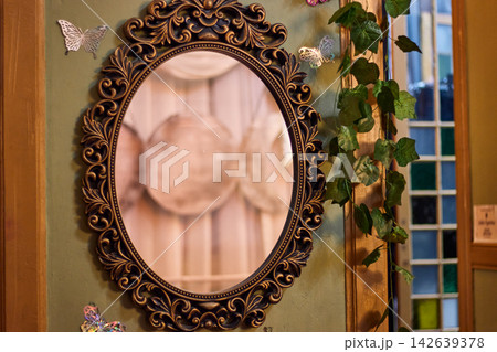 A well-decorated and maintained mirror, with a fantasy style, well-detailed, along with its ornaments, colors, and lights A well-decorated and maintained mirror, with a fantasy style, well-detailed, along with its ornaments, colors, and lights 142639378