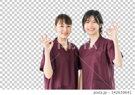 兩名女性醫護人員面帶微笑地比出「OK」手勢。她們身穿手術服的剪影照片,傳遞出一種令人安心和信任的感覺。 兩名女性醫護人員面帶微笑地比出「OK」手勢。她們身穿手術服的剪影照片,傳遞出一種令人安心和信任的感覺。 142639641