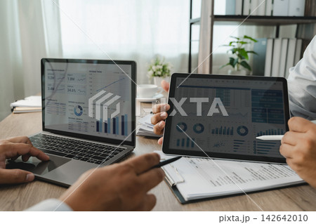 Business people reviewing financial performance  142642010