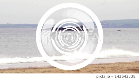 Surfacing whale fluke splashing near shore, showing breaking waves and white circular logo overlay Surfacing whale fluke splashing near shore, showing breaking waves and white circular logo overlay 142642339