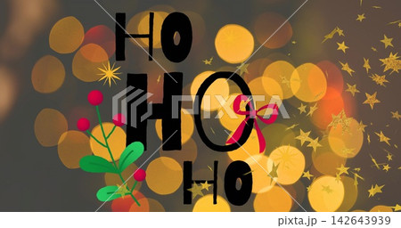 Featuring stacked black HO on dark-gray backdrop with holly, red ribbon, gold bokeh confetti 142643939