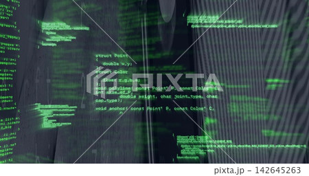 Glowing neon-green source code overlay filling dark workspace display with ribbed panel reflections 142645263