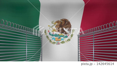 Showing central white stripe Mexican flag with coat-of-arms in studio with fences and razor wire 142645614