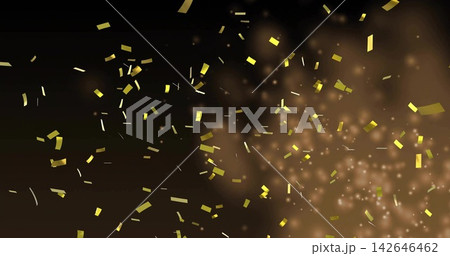 Glittering gold rectangles thin strips and square bits drifting across dark studio with bokeh glow 142646462