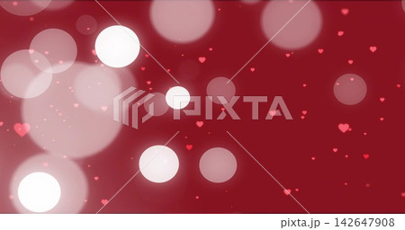 Floating large bokeh orbs creating glow halos on red gradient backdrop, scattering heart particles 142647908