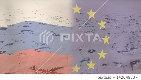Showing scattered footprints on snowy plain with tricolor left and blue star field right overlaying Showing scattered footprints on snowy plain with tricolor left and blue star field right overlaying 142648337