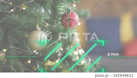 Showing decorated fir branch featuring red swirl ornament, gold ball, warm lights, HUD 2388 in home Showing decorated fir branch featuring red swirl ornament, gold ball, warm lights, HUD 2388 in home 142649612