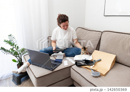 Budgeting pet expenses: planning a budget for kitten care in a bright living room 142650369