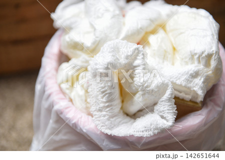 Diapers waste - dirty diapers in a garbage pail Disposing of used baby nappies Diapers waste - dirty diapers in a garbage pail Disposing of used baby nappies 142651644
