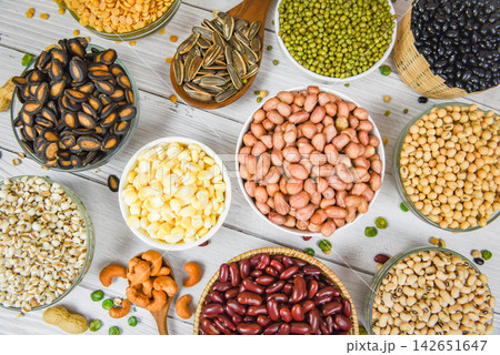 Different whole grains beans on bowl and legumes seeds lentils and nuts colorful snack background top view - Collage various beans mix peas agriculture of natural healthy food for cooking ingredients Different whole grains beans on bowl and legumes seeds lentils and nuts colorful snack background top view - Collage various beans mix peas agriculture of natural healthy food for cooking ingredients 142651647