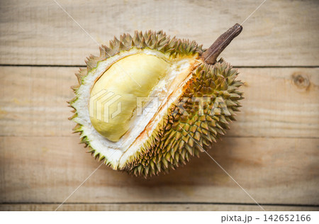 Durian riped / Fresh durian peel tropical fruit on wooden background on summer Durian riped / Fresh durian peel tropical fruit on wooden background on summer 142652166