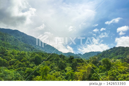 Tropical mountain jungle forest trees clouds and blue sky Brazil. Tropical mountain jungle forest trees clouds and blue sky Brazil. 142653393