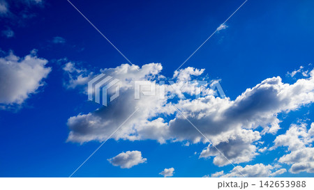 cumulus white clouds with soft dark shadows set against a clear blue sky cumulus white clouds with soft dark shadows set against a clear blue sky 142653988
