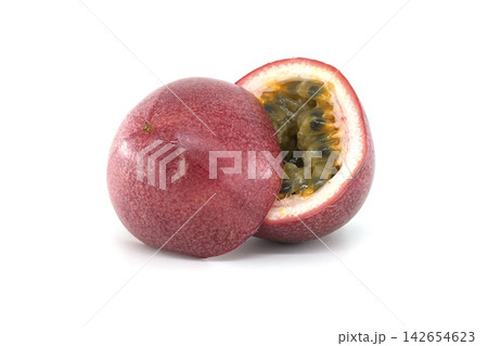 Ripe passion fruit cut in half revealing juicy pulp and seeds on white background Ripe passion fruit cut in half revealing juicy pulp and seeds on white background 142654623