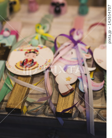 Greek Easter candles, assortment selection of handmade crafted traditional lambada, multicoloured wax candles with ribbon for sale in local store market, Orthodox Easter traditions in Athens, Greece Greek Easter candles, assortment selection of handmade crafted traditional lambada, multicoloured wax candles with ribbon for sale in local store market, Orthodox Easter traditions in Athens, Greece 142654707