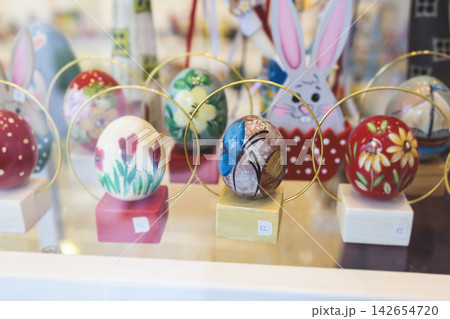 Easter in Greece, caffe and shop decorations, bunnies, multicoloured easter eggs, decorated shopwindow, Easter gifts and souvenirs, showcase, glass case, shopfront decorated in Athens, Attica, Greece Easter in Greece, caffe and shop decorations, bunnies, multicoloured easter eggs, decorated shopwindow, Easter gifts and souvenirs, showcase, glass case, shopfront decorated in Athens, Attica, Greece 142654720