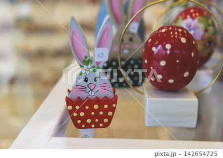 Easter in Greece, caffe and shop decorations, bunnies, multicoloured easter eggs, decorated shopwindow, Easter gifts and souvenirs, showcase, glass case, shopfront decorated in Athens, Attica, Greece 142654725