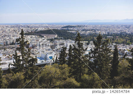 Athens, Attica, Greece, beautiful panoramic view of Athens cityscape, with The Parthenon, mountains, sea and scenery beyond the city, seen from Mount Lycabettus Hill observation deck in a sunny day Athens, Attica, Greece, beautiful panoramic view of Athens cityscape, with The Parthenon, mountains, sea and scenery beyond the city, seen from Mount Lycabettus Hill observation deck in a sunny day 142654784
