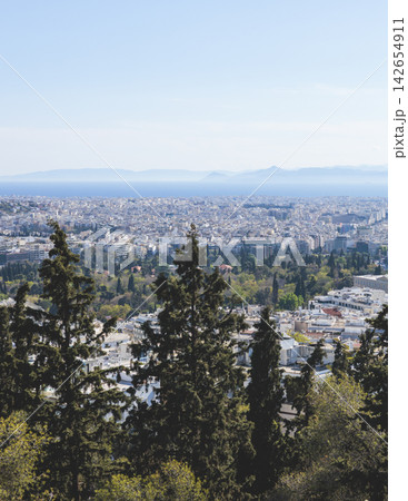Athens, Attica, Greece, beautiful panoramic view of Athens cityscape, with The Parthenon, mountains, sea and scenery beyond the city, seen from Mount Lycabettus Hill observation deck in a sunny day Athens, Attica, Greece, beautiful panoramic view of Athens cityscape, with The Parthenon, mountains, sea and scenery beyond the city, seen from Mount Lycabettus Hill observation deck in a sunny day 142654911
