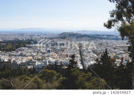 Athens, Attica, Greece, beautiful panoramic view of Athens cityscape, with The Parthenon, mountains, sea and scenery beyond the city, seen from Mount Lycabettus Hill observation deck in a sunny day Athens, Attica, Greece, beautiful panoramic view of Athens cityscape, with The Parthenon, mountains, sea and scenery beyond the city, seen from Mount Lycabettus Hill observation deck in a sunny day 142654927