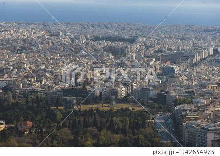 Athens, Attica, Greece, beautiful panoramic view of Athens cityscape, with The Parthenon, mountains, sea and scenery beyond the city, seen from Mount Lycabettus Hill observation deck in a sunny day Athens, Attica, Greece, beautiful panoramic view of Athens cityscape, with The Parthenon, mountains, sea and scenery beyond the city, seen from Mount Lycabettus Hill observation deck in a sunny day 142654975