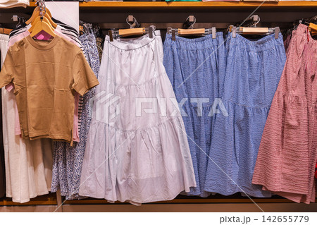 Colorful Dresses and Skirts on Clothing Rack 142655779