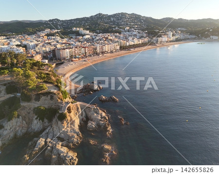 Aerial view taken from a drone of the coast of Lloret de Mar, Costa Brava, Spain, early in the morning at sunrise - the sea, beach and coastal hotels 142655826