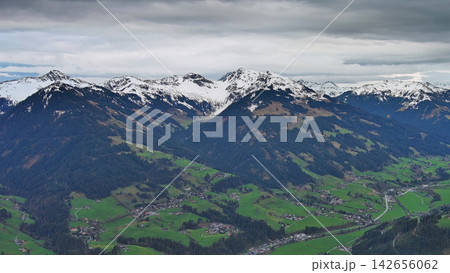 Aerial view of alpine valley with mountains and clouds Aerial view of alpine valley with mountains and clouds 142656062