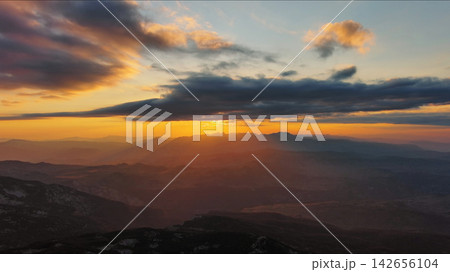 Sunset over mountain with dramatic clouds Sunset over mountain with dramatic clouds 142656104