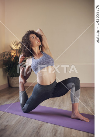 Girl, yoga or mermaid pose in house for health, wellness or body flexibility for practice routine. Woman, zen yogi or female person in pilates session for mindfulness, wellbeing or balance on mat 142658276