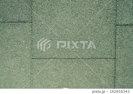 High angle close up shot of a green textured rubber flooring with straight geometric seams High angle close up shot of a green textured rubber flooring with straight geometric seams 142658343