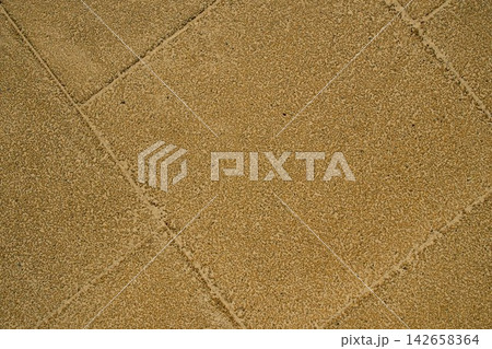 High angle close up shot of a yellow textured rubber flooring with geometric seams on a modern children playground High angle close up shot of a yellow textured rubber flooring with geometric seams on a modern children playground 142658364
