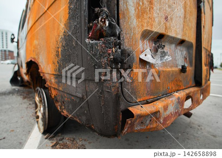 Rusty Flaking Metal Body Panel of a Burnt Out Vehicle Rusty Flaking Metal Body Panel of a Burnt Out Vehicle 142658898