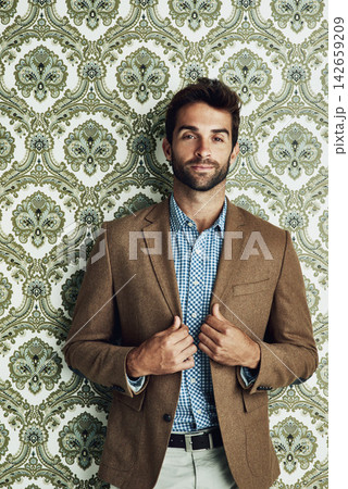 Man, portrait and fashion on wallpaper or stylish confidence with suit jacket with pattern background, classy or pride. Male person, face and beard with clothing for party event, trendy or relaxed 142659209