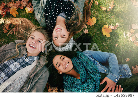 Above, teenagers or girls on park for autumn, relaxing and bonding together on grass with happiness. Nature, lawn and friends on summer holiday for chilling, hanging out and laugh outdoors with smile Above, teenagers or girls on park for autumn, relaxing and bonding together on grass with happiness. Nature, lawn and friends on summer holiday for chilling, hanging out and laugh outdoors with smile 142659987