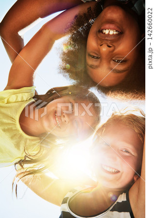 Happy, low angle and portrait of children with sunshine for friendship, playing and fun on camp. Diversity, youth and girls huddle for childhood, game and hug for school, recess and playground 142660022