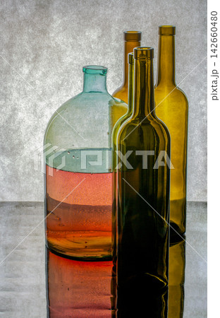 Still life with colored glass bottles Still life with colored glass bottles 142660480