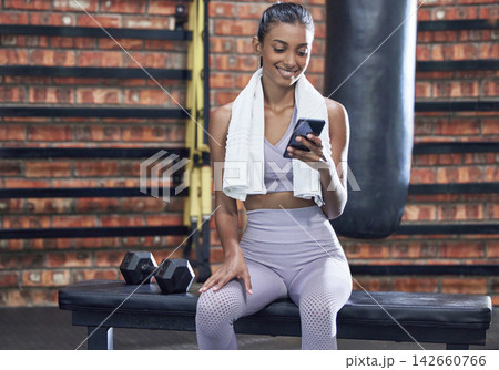 Happy woman, fitness and break with phone at gym for browsing or online search on workout or exercise. Female person with smile on mobile smartphone for training tips, news or app at health club 142660766