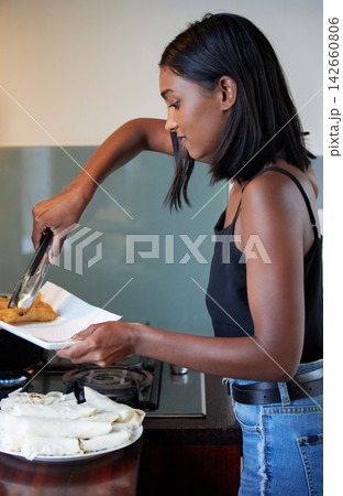 Cooking, food and woman in kitchen at apartment for Asian dinner, lunch or snack with pastry. Health, meal and female person frying crispy springroll in pan on stove for supper cuisine at home. Cooking, food and woman in kitchen at apartment for Asian dinner, lunch or snack with pastry. Health, meal and female person frying crispy springroll in pan on stove for supper cuisine at home. 142660806