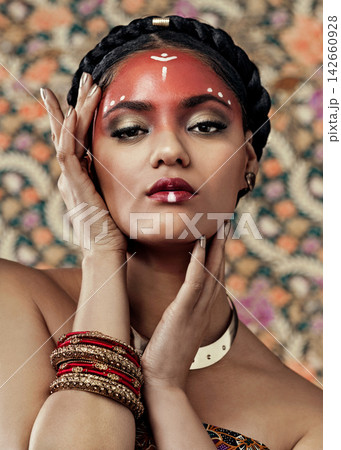 Africa, makeup and portrait for culture with black woman in studio on wallpaper background for tradition. Beauty, fashion and heritage with confident young tribal person in face paint for ritual Africa, makeup and portrait for culture with black woman in studio on wallpaper background for tradition. Beauty, fashion and heritage with confident young tribal person in face paint for ritual 142660928