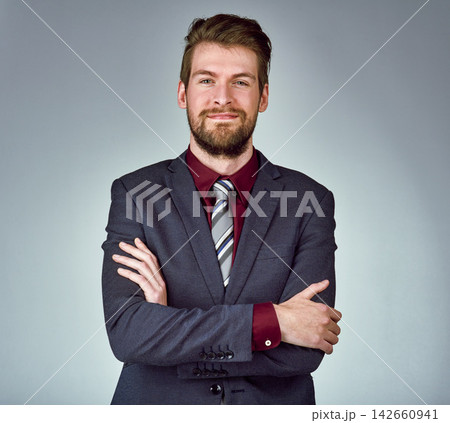 Portrait, confident and happy businessman in studio as lawyer at firm with goal for company growth or future. Smile, male person and corporate with arms crossed for mission or project in agency 142660941