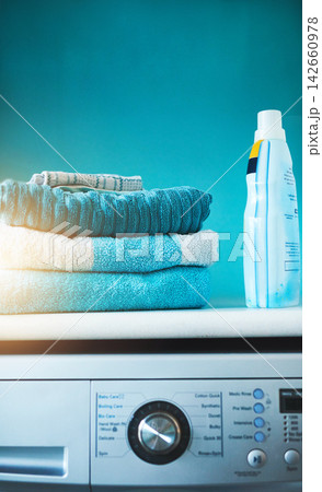 Washing machine, clothes and clean laundry in blue background with technology, product and mockup. Lens flare, fabric and digital load for energy, efficiency and furniture with fast results. 142660978