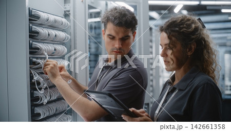 Two Data Center Engineers Performing Dual Control Network Maintenance Two Data Center Engineers Performing Dual Control Network Maintenance 142661358