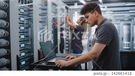 Male IT Specialist Investigating Critical Thermal Incident Through Linux Terminal in Data Center. 142661418